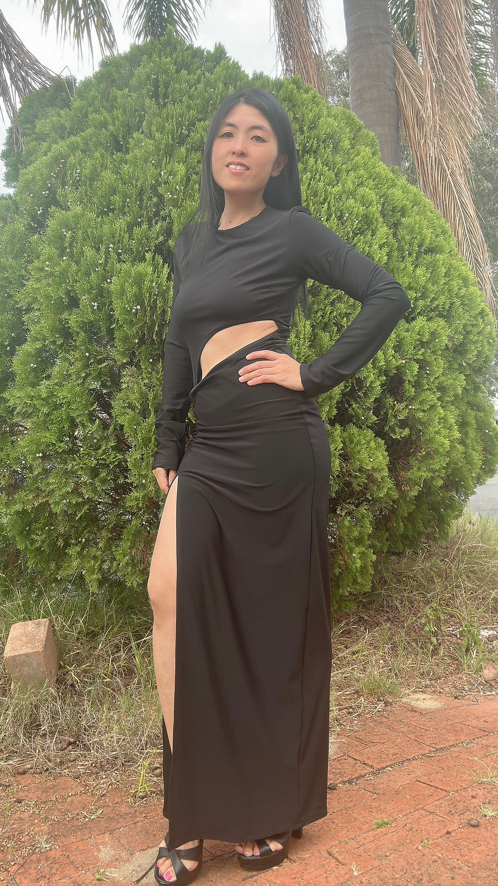 Thumbnail: Rhapso Designs Boutique Asymmetrical long sleeve cutout maxi dress in black front view