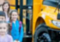 Elementary school kids near a bus