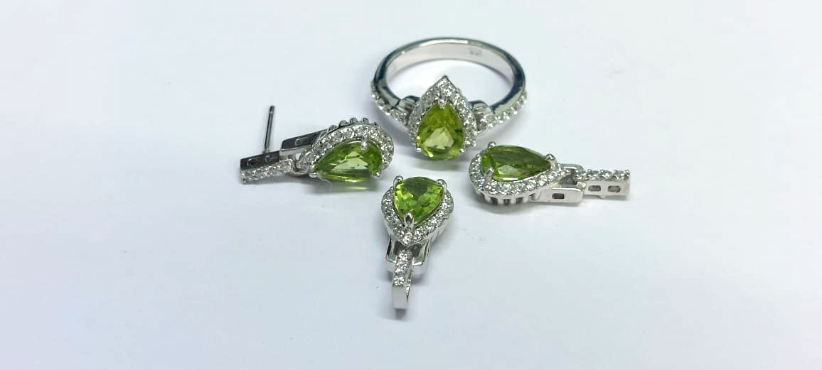 Peridot and  Diamond pear cut set featuring a ring, earrings and pendant in white gold