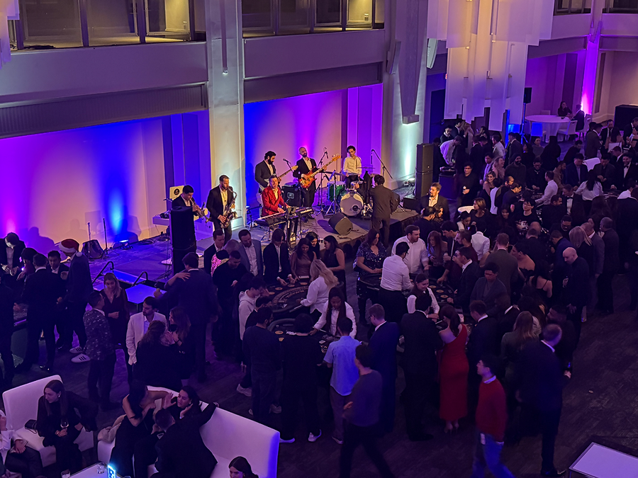 Live band performing at a large-scale corporate gala with guests networking