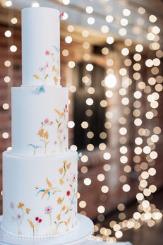 Three tier, fondant covered wedding cake with hand painted florals. A truly unique  cake. East Yorkshire