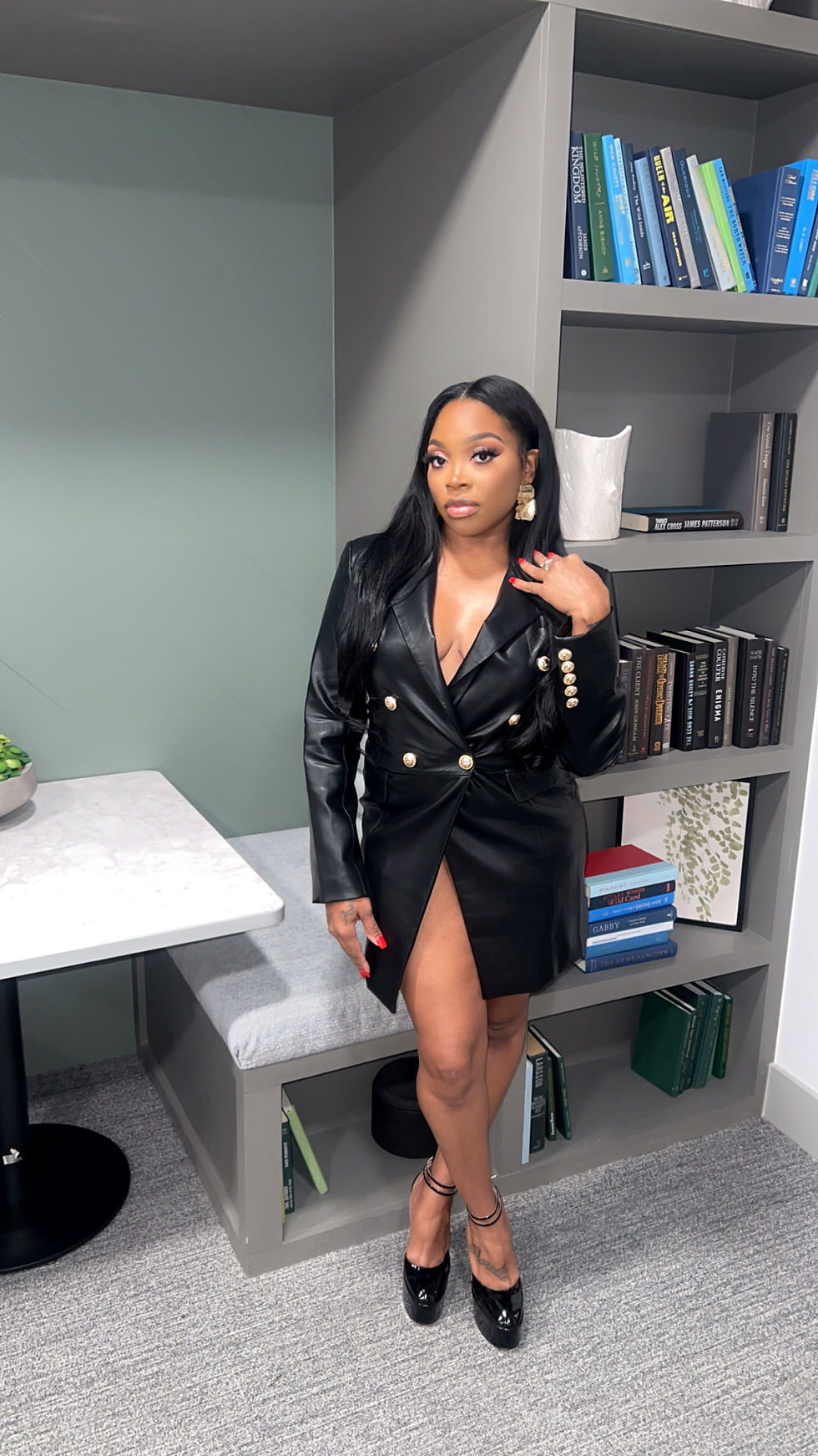 Short black leather long sleeve dress with gold buttons and zipper.