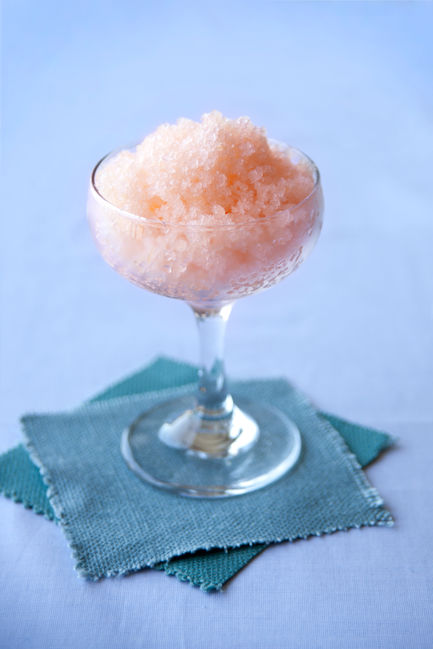 Grapefruit Granita, Pink shaved ice in a glass on napkins.