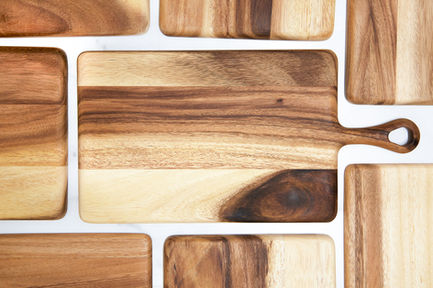 Handmade wooden cutting boards with varied grain patterns.