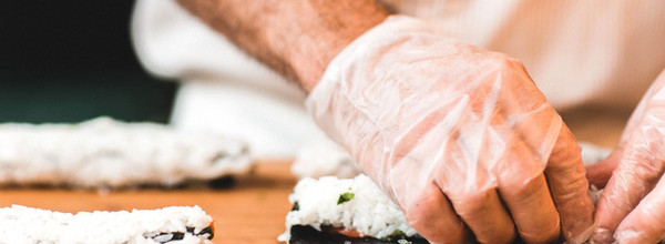 Close up of chef crafting sushi rolls at Raw Sushi Bistro
