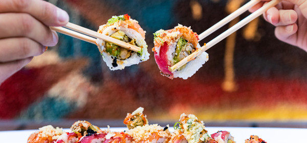 Artfully plated sushi rolls with chopsticks at Raw Sushi Bistro