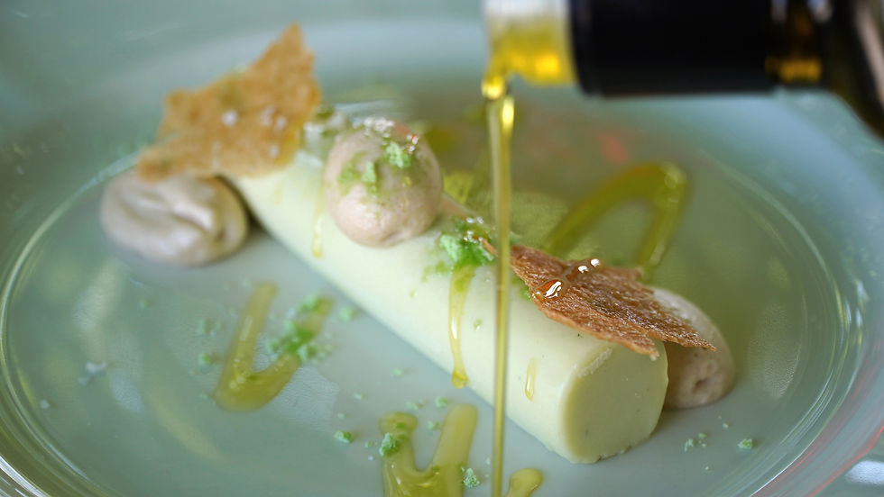 A delicate dessert where creamy white chocolate is gently infused with olive leaves and paired with a light almond mousse and crisp buttery wafer. Finish with your finest extra virgin olive oil for a surprisingly elegant combination.