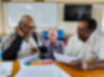 A doctor being trained by another doctor at a desk