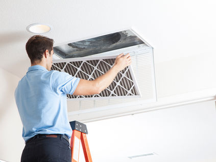 HVAC technician performing professional air duct cleaning in Coachella Valley home