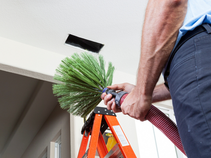 Professional Air Duct Cleaning Palm Desert CA technician removing dust from vents