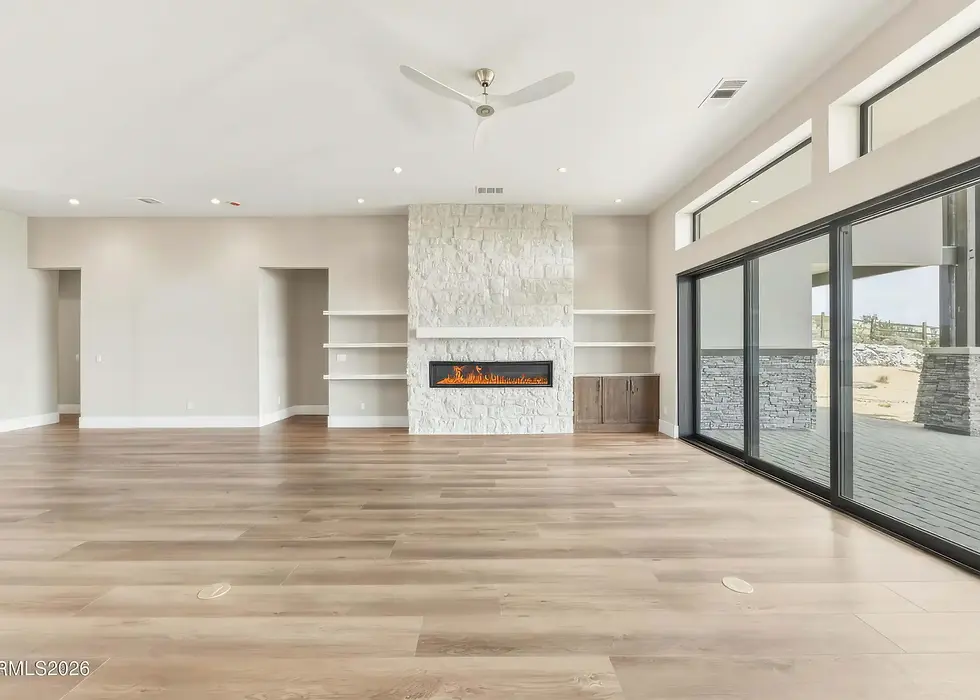 Amateur real estate photo of Reno luxury new-build living room — flat lighting, distorted angle