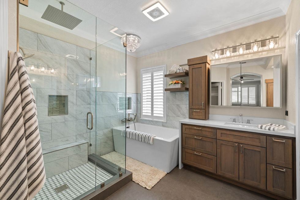Full bathroom view highlighting the glass shower, alder vanity, and bright, spa-like finishes.