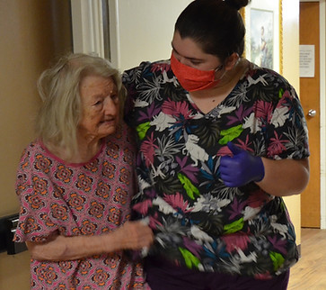 Caregiver assisting a resident to her room