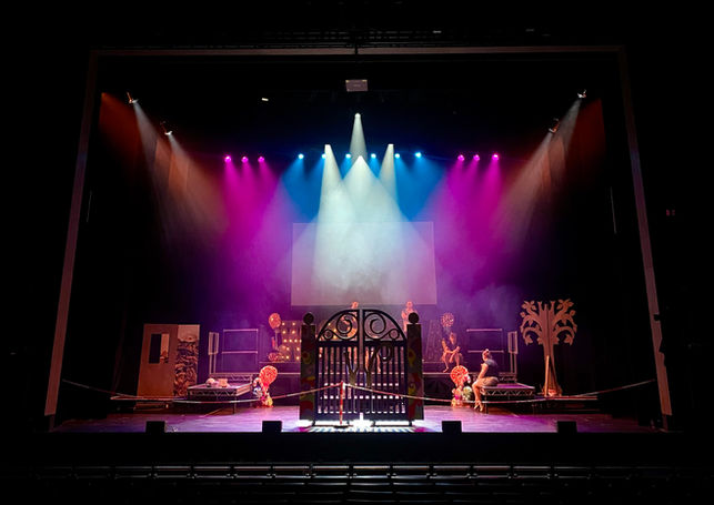 A wide shot of the stage lit in blue, pink and white.
