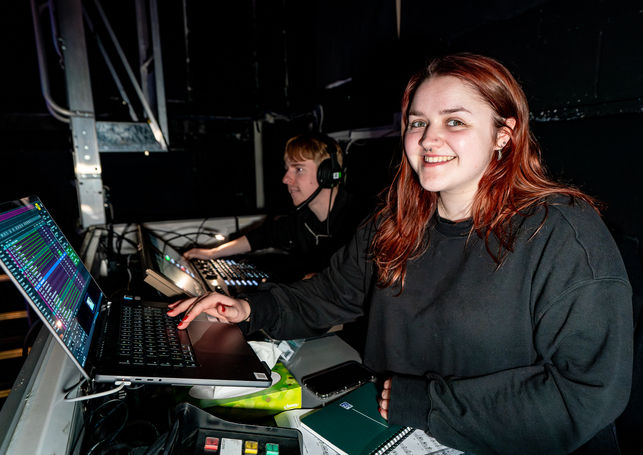 Video technician (me!) posing at the tech desk