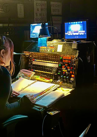 The Deputy Stage Manager sat at her desk with the script in front of her calling cues