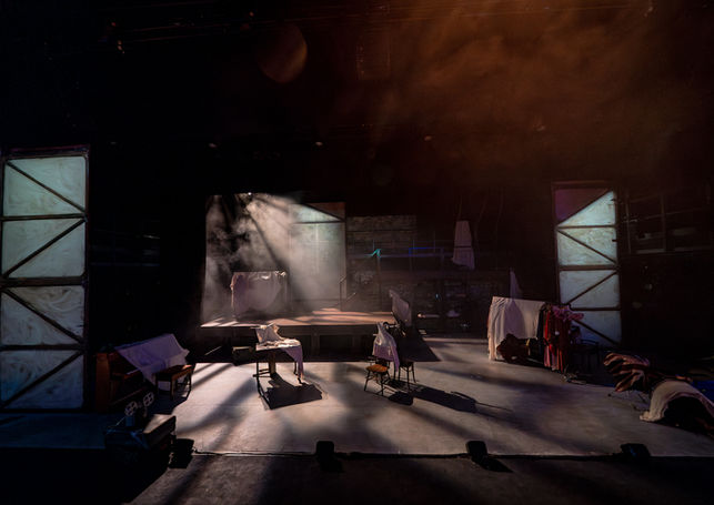 A wide shot of an empty stage lit in cold white