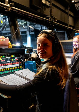 The deputy stage manager and video technician (me!) posing at their desks
