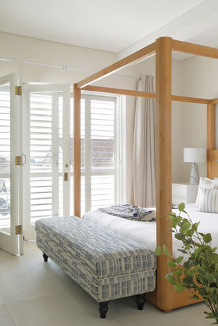 Bright accommodation bedroom with four-poster bed