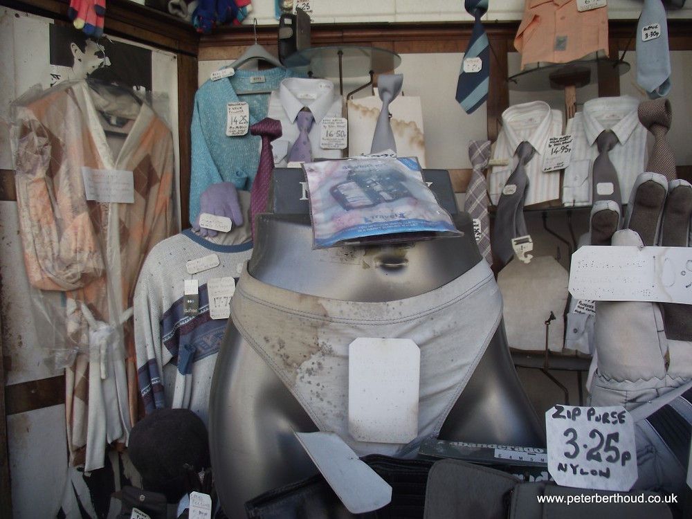 Shop window of George Moore Menswear, 99, Myddleton Road, N22
