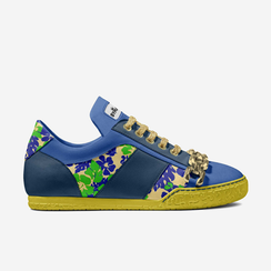Blue sneaker with floral pattern, gold chain detail, and yellow sole.