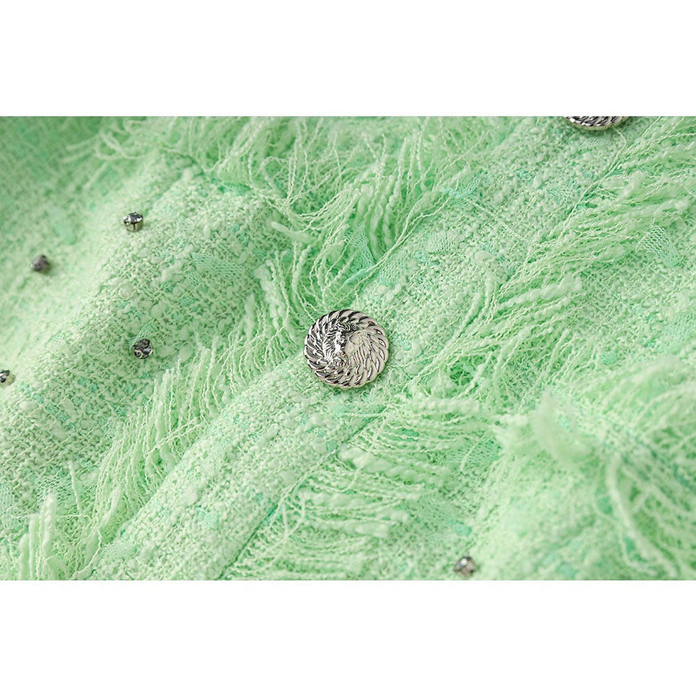 Thumbnail: Close-up of fuzzy light green fabric with silver embellished buttons and studs.