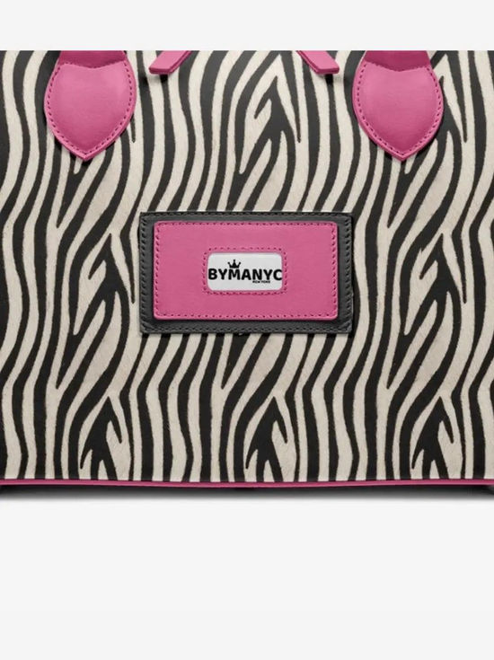 Zebra print bag with pink trim, handles, and "BYMANYNC" label.