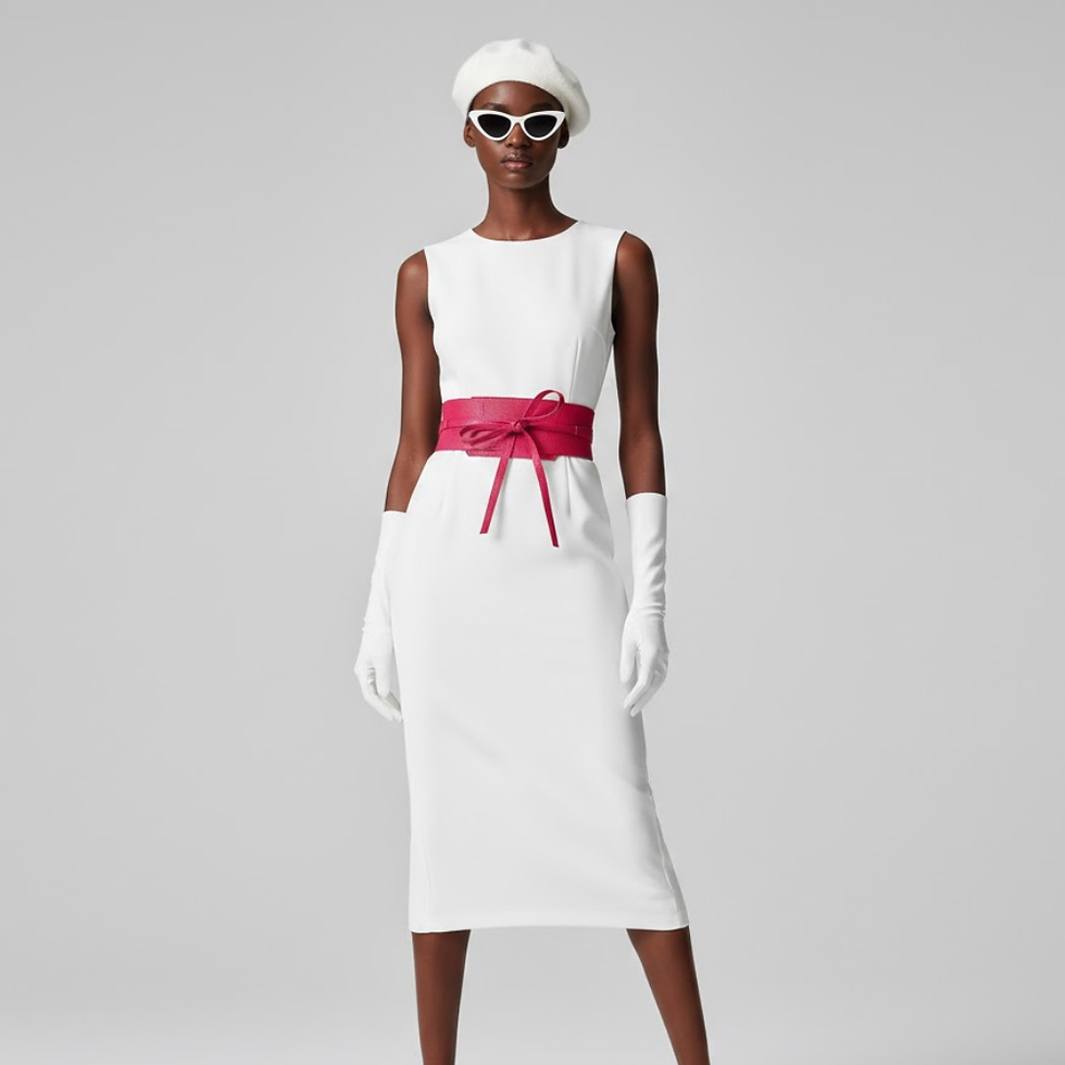 Woman in white beret, sunglasses, sleeveless dress, gloves, and red obi belt.