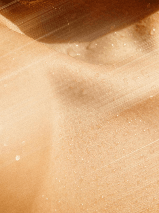 Healthy skin with refreshing water droplets, showing hydration and cleanliness.