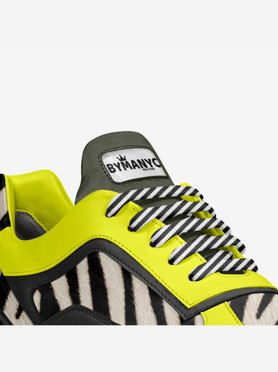 Close-up modern shoe, BYMANYC, neon yellow, zebra print, striped laces.