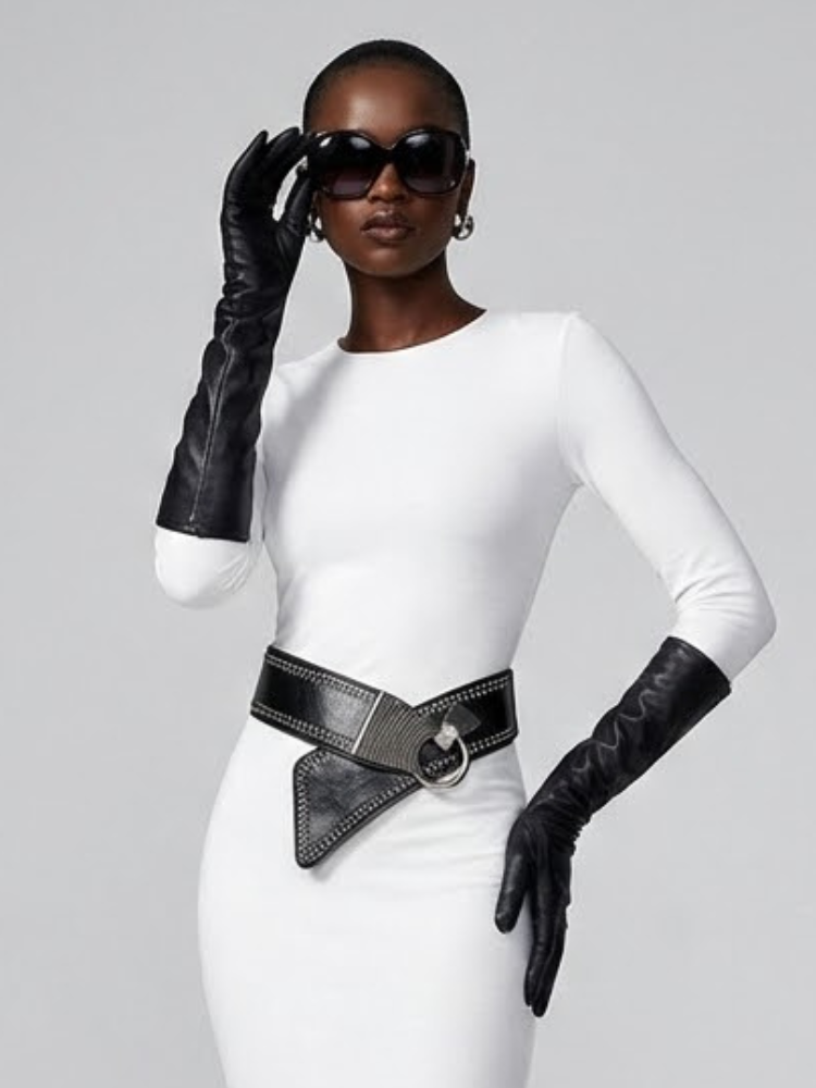 Woman in white dress, opera gloves, sunglasses, and stylish black belt.