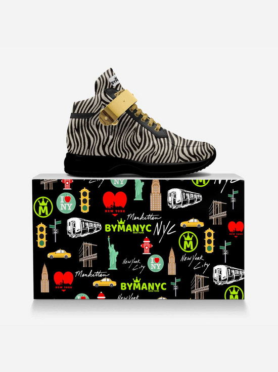BYMANYC zebra print high-top sneaker, gold strap, on NYC themed shoebox.
