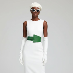 Stylish woman in white dress, beret, gloves, and prominent green belt.