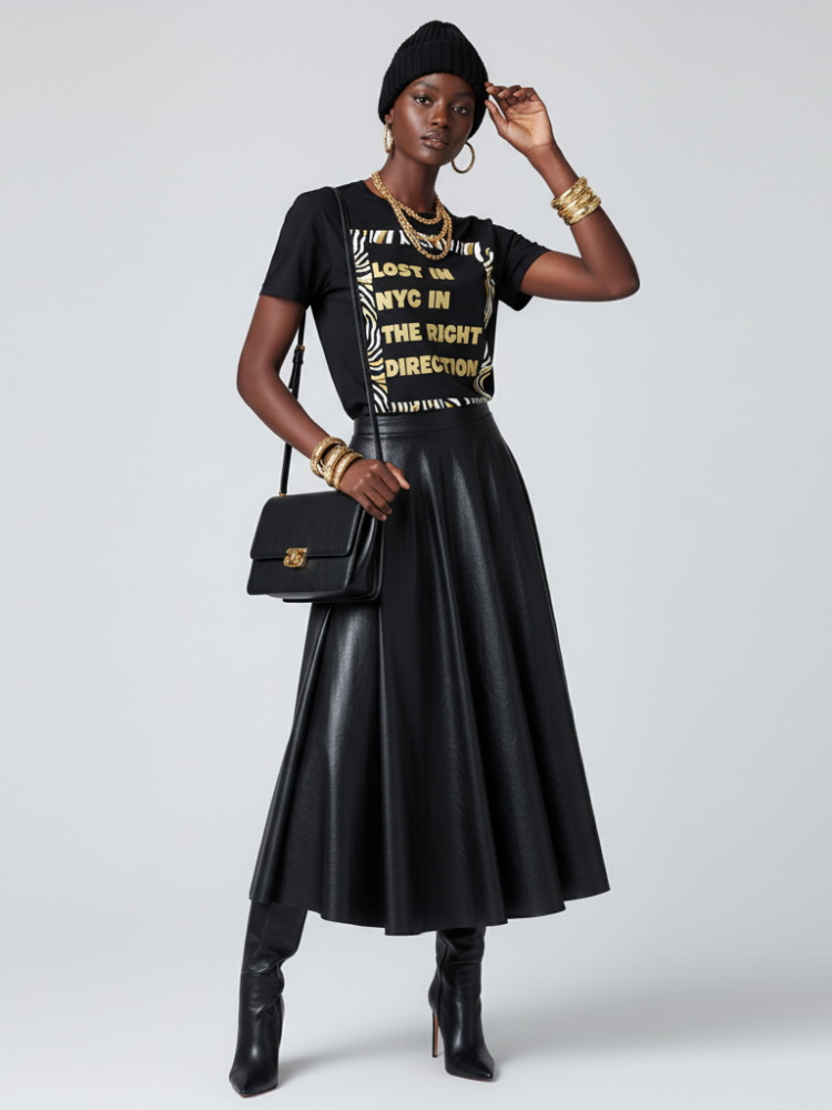 Thumbnail: Model in black t-shirt "LOST IN NYC IN THE RIGHT DIRECTION", pleated skirt.