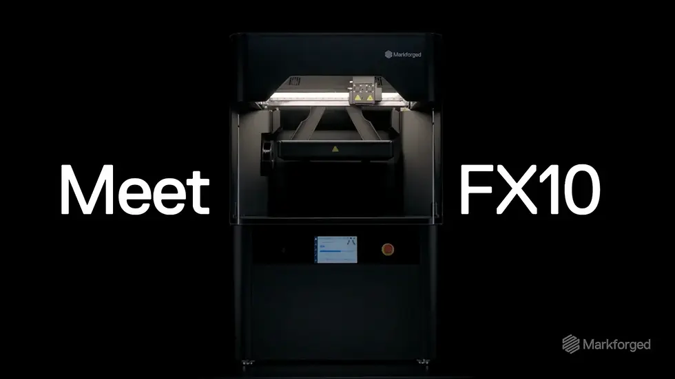 Image of Markforged’s FX10 3D printer in industrial setting, showing robust frame, automated compartments, and continuous fiber + metal printing capabilities.