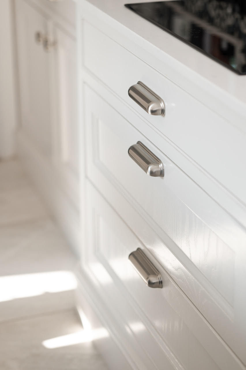 White kitchen drawers with brushed nickel pulls