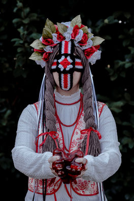 A life size Ukrainian doll holds a bloodied blob.