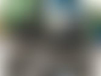 Garbage truck causing pavement damage near dumpster in commercial parking lot