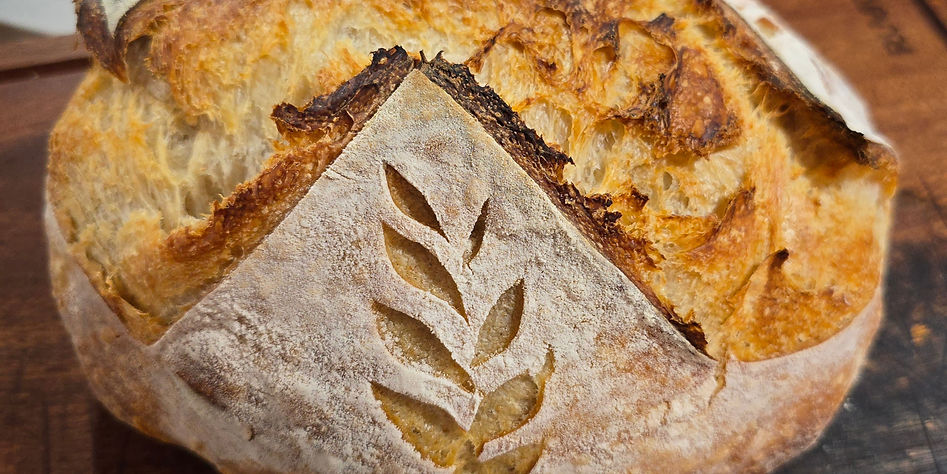 sourdough batard loaf on a wooden cutting board
