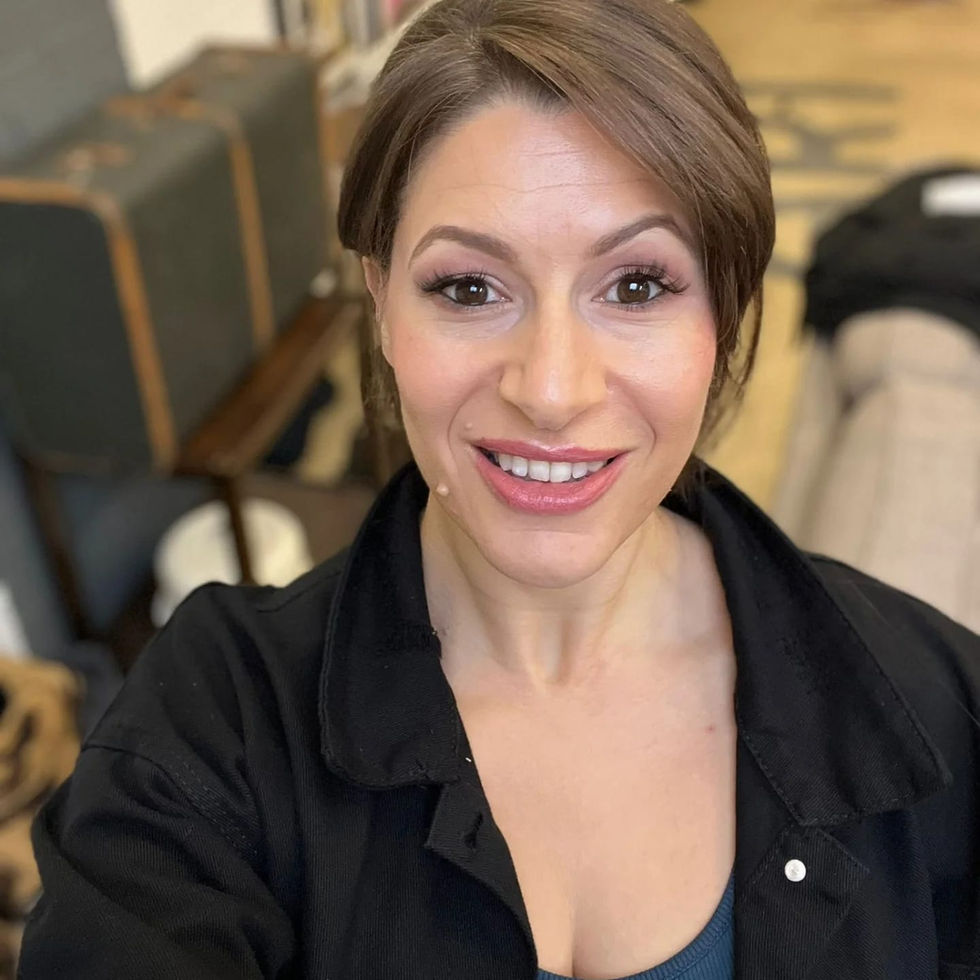 a woman in a black shirt is smiling for the camera