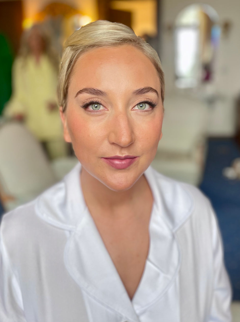 a close up of a woman 's face with a white shirt on