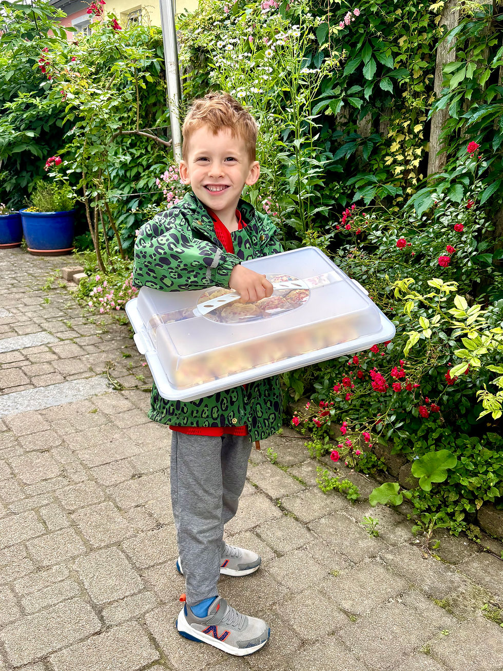 Leo proudly delivering cupcakes for his last kindergarten day