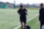 A player performs a sled drag on a 3G pitch as part of a recovery-focused session. Ed stands alongsi