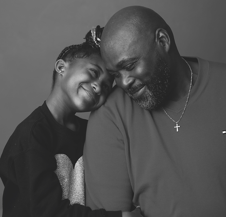 Black and White Photo of a Black Grandfather and Granddaughter Sharing a Sweet Smile In this captivating black and white photo, a black grandfather and his precious granddaughter are captured in a heartwarming moment of connection. Both individuals can be seen smiling warmly at each other, radiating pure joy and affection. The monochromatic tones add a timeless touch, enhancing the emotional impact of the image. This tender photograph beautifully showcases the special bond between generations, showcasing the love, guidance, and happiness shared between a grandfather and his granddaughter. The black and white composition adds a touch of nostalgia and emphasizes the genuine expressions on their faces. This SEO-optimized image description highlights the key elements of the photo, incorporating relevant keywords such as black and white photo, black grandfather, granddaughter, smiling, and love. It aims to effectively convey the emotion and essence of the image to