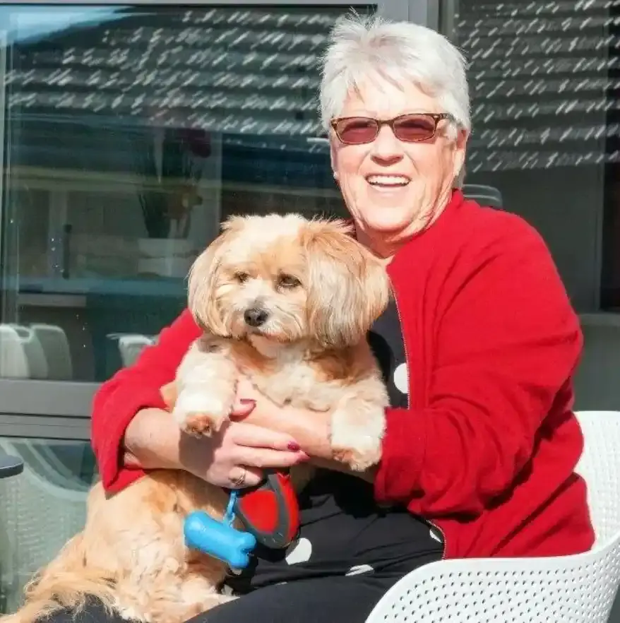 Longridge resident with her dog outside her villa