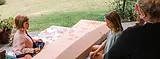 Family decorating a personalised cardboard casket by Outside The Box Caskets