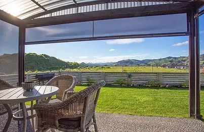 Covered patio and countryside views from Villa 49 at Longridge Country Estate, Paeroa