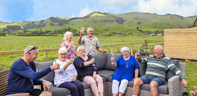 Longridge residents enjoying a drink together outside with lush green hills in the background