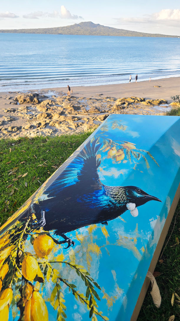 Tūī song printed casket lid with New Zealand landscape in the background