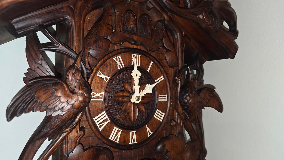 Close-up view of a beautifully restored cuckoo clock with intricate carvings